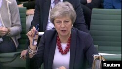 A still image from video footage shows Britain's Prime Minister Theresa May speaking at a Select Committee hearing, in London, Nov. 29, 2018. 