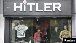 A customer walks out of a garment store named 'Hitler' in the western Indian city of Ahmedabad, September 4, 2012. 