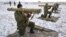FILE- Ukrainian soldiers perform weapons exercise at training ground outside Lviv, western Ukraine, Feb. 5, 2015.