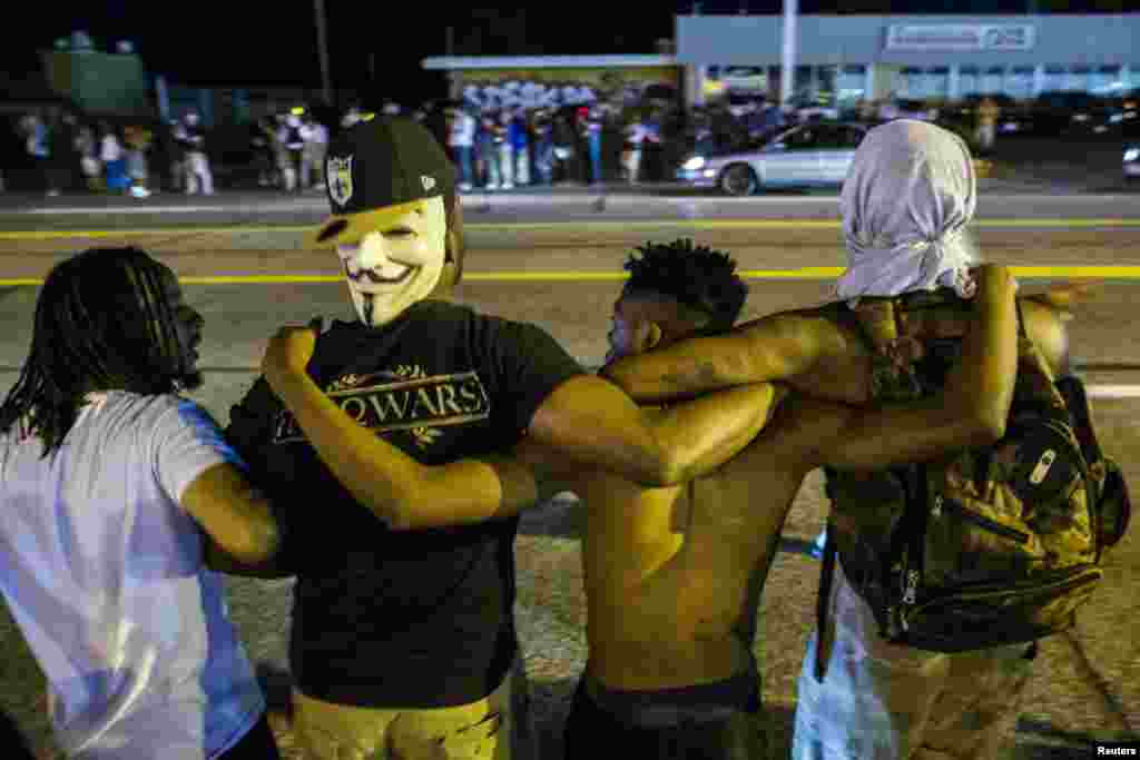 Protesters lock arms during another night of demonstrating in Ferguson, Aug. 11, 2015.