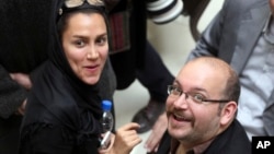 FILE - Jason Rezaian, an Iranian-American correspondent for The Washington Post, and his wife Yeganeh Salehi, attend a presidential campaign of President Hassan Rouhani in Tehran, April 11, 2013. 