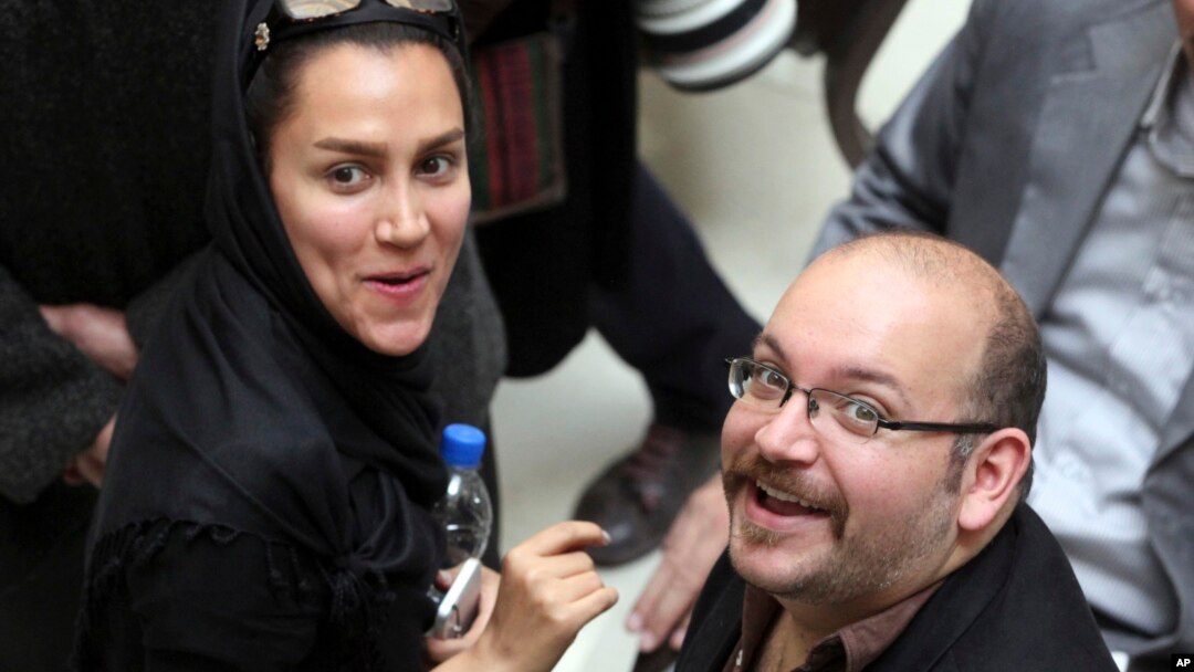 FILE - Jason Rezaian, an Iranian-American correspondent for The Washington Post, and his wife Yeganeh Salehi, an Iranian correspondent for Abu Dhabi-based newspaper The National, attend a presidential campaign of President Hassan Rouhani in Tehran, April 11, 2013. 