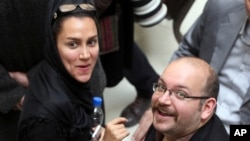 FILE- Jason Rezaian (R), an Iranian-American correspondent for The Washington Post, and his wife Yeganeh Salehi, an Iranian correspondent for the Abu Dhabi-based newspaper The National, attend a presidential campaign of President Hassan Rouhani in Tehran, Iran, April 11, 2013. 