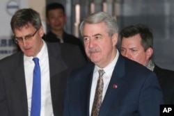 FILE - U.S. Undersecretary for Trade and Foreign Agricultural Affairs Ted McKinney, center, leaves from a hotel for meetings with Chinese officials in Beijing, China, Jan. 8, 2019.