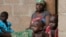 FILE - A mother sits with her children in Wurojuli, Gombe State, Nigeria, Sept. 2, 2014. Africa's children may account for nearly half of the world’s poor by 2030, a report by the Overseas Development Institute says.