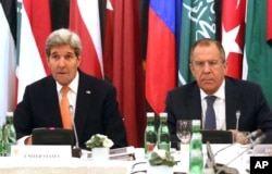U.S. Secretary of State John Kerry, left, and Russian Foreign Minister Sergey Lavrov confer in Vienna, Austria, Nov. 14, 2015. Foreign ministers from more than a dozen nations are meeting in Vienna seeking to find a way to resolve the conflict in Syria.