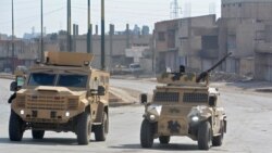 Syrian Democratic Forces (SDF) patrol a street in the northern Syrian city of Hasakeh on Jan. 23, 2022.