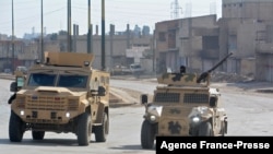Syrian Democratic Forces (SDF) patrol a street in the northern Syrian city of Hasakeh on Jan. 23, 2022.