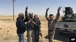 Libyan rebels celebrate as their shell hit its target outside Brega, Libya. Libyan government forces unleashed a withering bombardment of the rebels outside a key oil town pushing them back, even as the regime said Moammar Gadhafi might consider some refo
