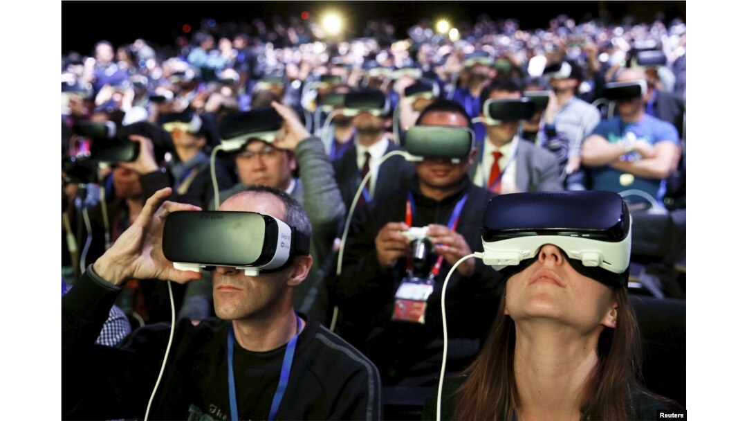 FILE - People wear Samsung Gear VR devices as they attend the launching ceremony of the new Samsung S7 and S7 edge smartphones during the Mobile World Congress in Barcelona, Spain, Feb. 21, 2016.