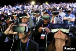 FILE - People wear Samsung Gear VR devices as they attend the launching ceremony of the new Samsung S7 and S7 edge smartphones during the Mobile World Congress in Barcelona, Spain, Feb. 21, 2016.