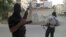 In this Thursday, June 28, 2012 photo, Members of the Free Syrian Army are seen in a neighborhood of Damascus, Syria. 