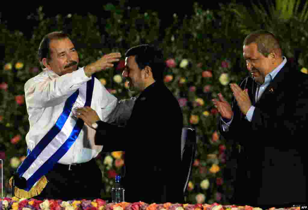 Mr. Ahmadinejad congratulates Nicaragua's President Daniel Ortega, who was sworn in for his second term as president on January 10, 2012. Venezuela's President Hugo Chavez claps on the right. (Reuters)