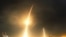 FILE - A long-exposure photograph shows the SpaceX Falcon 9 lifting off (L) from its launch pad and then returning to a landing zone (R) at the Cape Canaveral Air Force Station, in Cape Canaveral, Florida, Dec. 21, 2015.