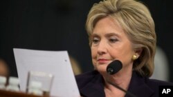 FILE - Democratic presidential candidate, former Secretary of State Hillary Rodham Clinton looks at an email sent by Ambassador Chris Stevens during her testimony before the House Benghazi Committee, Oct. 22, 2015, on Capitol Hill in Washington. 