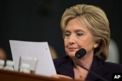 FILE - Democratic presidential candidate, former Secretary of State Hillary Rodham Clinton looks at an email sent by Ambassador Chris Stevens during her testimony before the House Benghazi Committee, Oct. 22, 2015, on Capitol Hill in Washington.