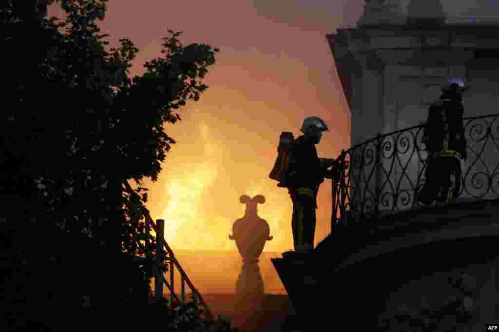 Firemen fight a blaze at the 17th-century Hotel Lambert in Paris, France.