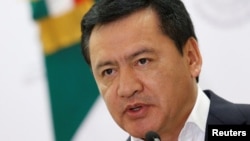 FILE - Mexico's Interior Minister Miguel Angel Osorio Chong gives a speech to the media during a news conference at the Interior Ministry building in Mexico City, Mexico.