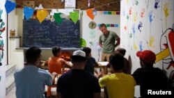 Refugee children attend a class at the volunteer-run "Refugee Education Chios" school on the island of Chios, Greece, Sept. 6, 2016. 