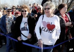 Jo Ann Taylor of Shreveport, Louisiana, front right, waits at the front of the line for the ribbon cutting to open the "Elvis Presley's Memphis" complex in Memphis, Tennessee, March 2, 2017.