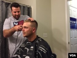 Liberty University graduates Dan Carr and Josh Close talk politics during a trim prior to commencement. (C. Presutti/VOA)
