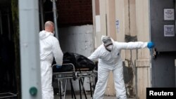 U.S. Army personnel remove the body of a deceased person from the The Riverside Premiere Rehabilitation & Healing Center senior facility on Manhattan's Upper West Side during the outbreak of the coronavirus disease in New York City, April 13, 2020.