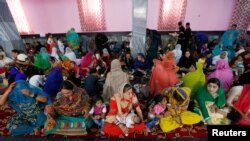 Afghan Hindu and Sikh families wait for lunch inside a Gurudwara, or a Sikh temple, during a religious ceremony in Kabul, Afghanistan, June 8, 2016.