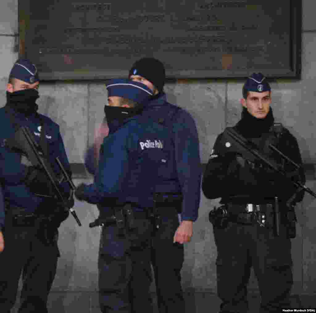 Police and soldiers guard Brussels' main train station, which is still open for passengers coming in from out of town, Nov. 24, 2015.