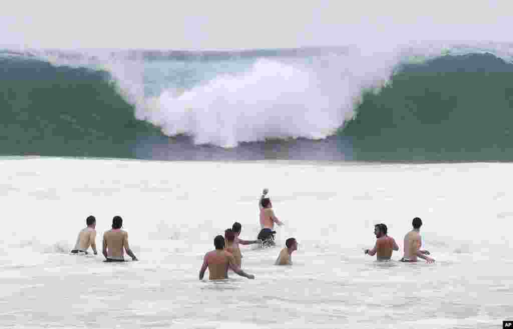 Italy players relax in the breakers of the Atlantic ocean at the soccer Confederations Cup in Rio de Janeiro, Brazil. 