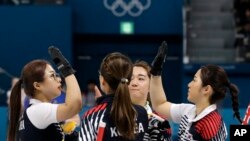 South Korea's women's curling team celebrate after beating Russian athletes during their match at the 2018 Winter Olympics in Gangneung, South Korea, Feb.21, 2018. The team known as the "Garlic Girls" came into the Pyeongchang Games as the underdog. Now they're No. 1 in the rankings.