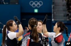 South Korea's women's curling team celebrate after beating Russian athletes during their match at the 2018 Winter Olympics in Gangneung, South Korea, Feb.21, 2018. The team known as the "Garlic Girls" came into the Pyeongchang Games as the underdog. Now t