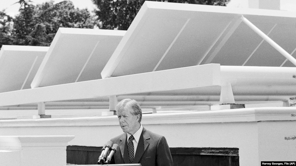 FILE - President Jimmy Carter speaks against a backｄrop of solar panels at the White House, June 21, 1979, in Washington.