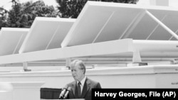 FILE - President Jimmy Carter speaks against a backdrop of solar panels at the White House, June 21, 1979, in Washington.