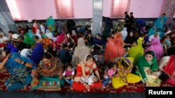 Afghan Hindu and Sikh families wait for lunch inside a Gurudwara, or a Sikh temple, during a religious ceremony in Kabul, Afghanistan, June 8, 2016.