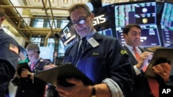 Trader Ronald Madarasz, center, works on the floor of the New York Stock Exchange, March 10, 2020. 