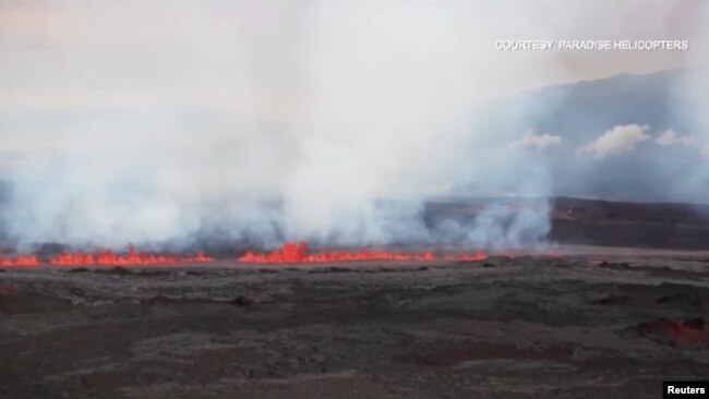 A view shows lava spewing from Hawaii's Mauna Loa volcano, Mauna Loa, Hawaii, U.S., November 28, 2022 in this screen grab taken from a handout video. Mick Kalber Tropical Visions Video/Handout via REUTERS