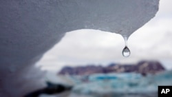 An iceberg melts in Kulusuk Bay, eastern Greenland, in this Tuesday July 17, 2007 file photo. (AP Photo/John McConnico)