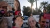 Relatives and supporters of Israeli hostages held by Hamas in Gaza hold photos of their loved ones during a protest calling for their return, in Tel Aviv, Israel, Jan. 8, 2025. 