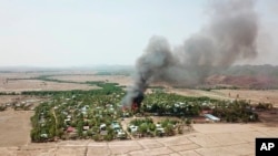 In this photo released by the Myanmar Army, a fire burns May 16, 2020, in the predominantly ethnic Rakhine village of Let Kar in Rakhine State's Mrauk-U township, western Myanmar. The Rakhine areas since January last year has been the scene of…