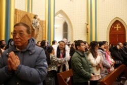 FILE - Worshippers attend Mass at Xishiku Cathedral, a government-sanctioned Catholic church, on Christmas Eve in Beijing, China, Dec. 24, 2019.