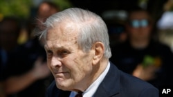 FILE - In this Sept. 11, 2019, file photo, former Defense Secretary Donald Rumsfeld attends a wreath laying ceremony on the grounds of the National 9/11 Pentagon Memorial at the Pentagon.