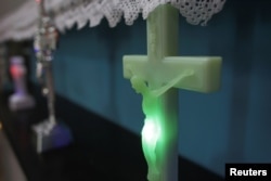 A LED light shines inside a plastic rendition of Jesus Christ on the cross at the newly opened Kitsch Museum in Bucharest, Romania, May 5, 2017.