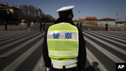 Chinese police wait for the arrival of delegates for a session of the National People's Congress outside the Great Hall of the People in Beijing, China, March 11, 2012. 