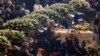 Relatives attend a funeral service for some of the victims of a collapsed highway bridge, in Genoa's exhibition center Fiera di Genova, Italy, Aug. 18, 2018. 