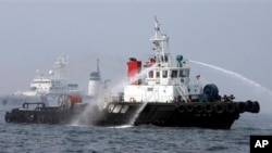 FILE - South Korean Coast Guard ship sprays dissolving agent over oil spilled by a South Korean tanker after an accident off Yeosu.