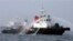 FILE - South Korean Coast Guard ship sprays dissolving agent over oil spilled by a South Korean tanker after an accident off Yeosu.