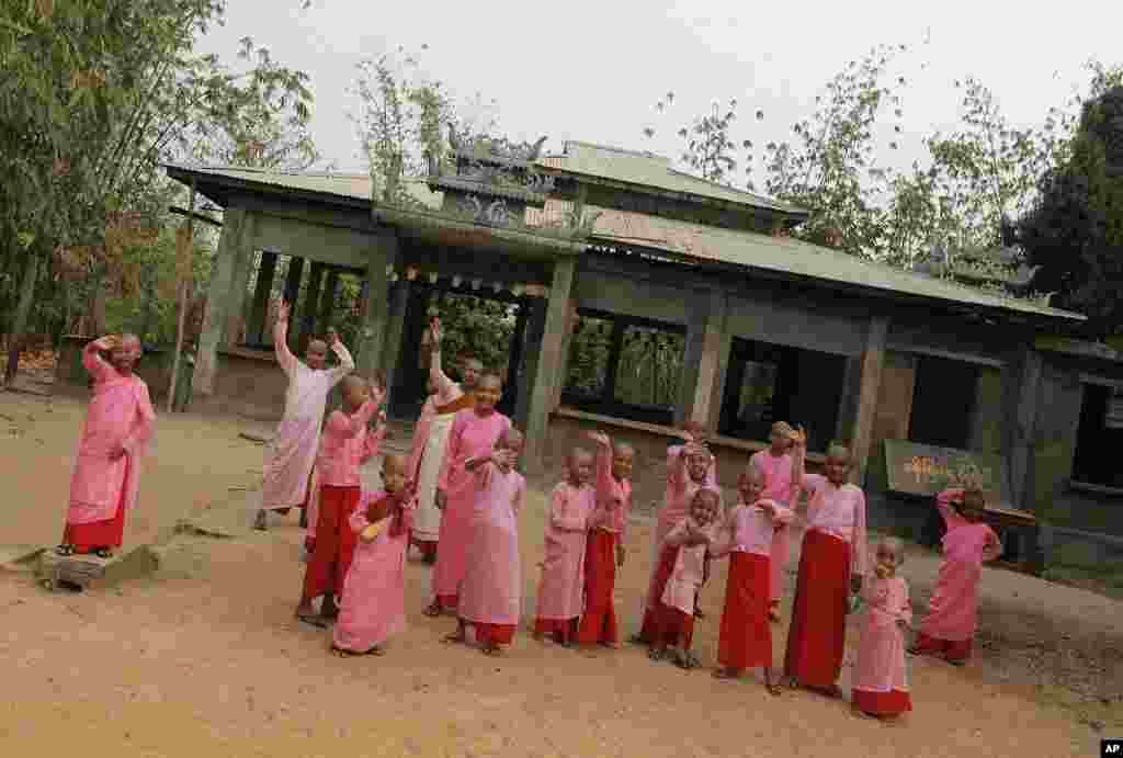 Buddhist novice nuns greet the convoy escorting Aung San Suu Kyi as she visits polling stations in Kawhmu township, April 1, 2012. (Reuters)