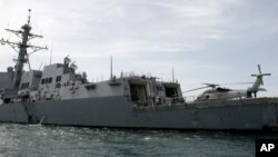 FILE - The guided missile frigate USS Mustin port upon the arrival near Cambodia's port town of Sihanoukville some 185 kilometers (115 miles) southwest of Phnom Penh, Cambodia.