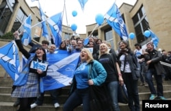 FILE - 'Yes' campaigners cheer during a rally in Glasgow, Scotland, Sept. 17, 2014.