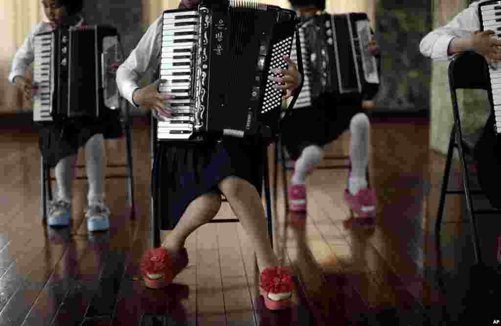 School girls perform a song during an accordion class in Pyongyang, North Korea. 